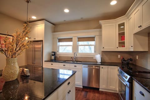 Gourmet Cooks Kitchen with slab granite counters & top end appliances