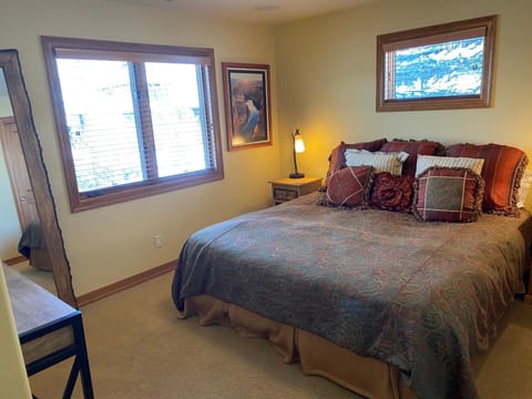 4th Upstairs king bedroom with 3/4 bath and luxury bedding.