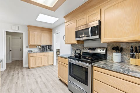 Kitchen includes an Electric Cooktop, Coffee Maker and Keurig. 