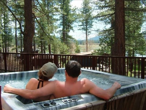 Relax in the hot tub and take in the meadow views