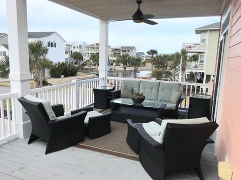 Sitting Area on Back Deck Includes Couch, Two Chairs and Large Ceiling Fan 