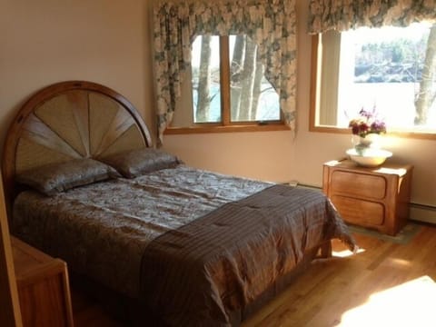 Master suite with a paddle fan, two bureaus and gorgeous lake and mountain views