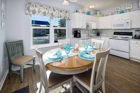 Large Dining & Kitchen area has large window with partial views of the Gulf