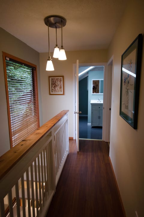 view looking down hallway into bathroom