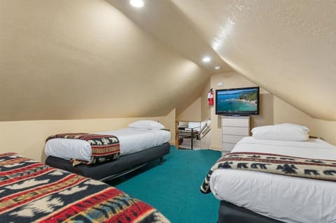 Loft with queen, 2 twins and TV. This is a great spot for families.