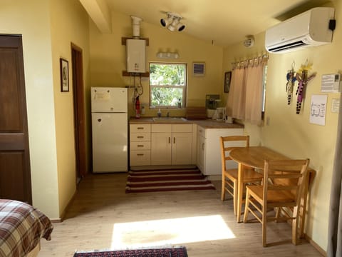 Partial kitchen in studio cottage. Bathroom off to the left.