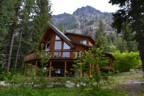 View of cabin with dirty face peak in the background.