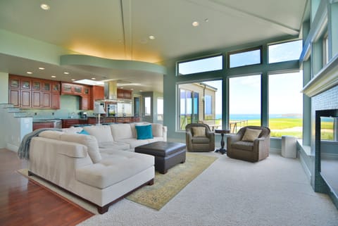 The luxurious living area with tons of natural light, ocean views and fireplac