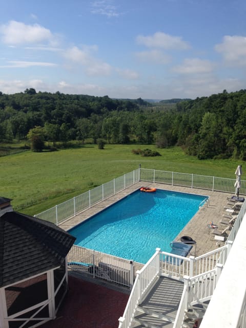 View of the pool and the Hudson Valley in the distance from the master bedroom.