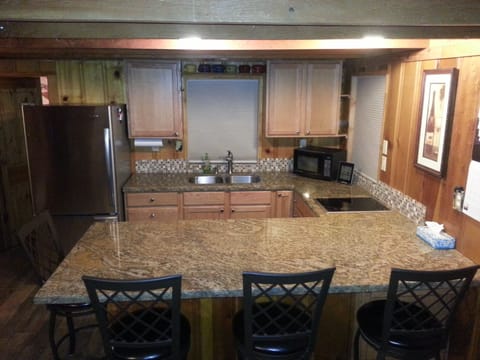 Stainless Steel, Granite Counter, Open Kitchen. Seating for 4 at counter.