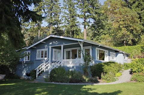 Private home with manicured lawn and flower gardens. 