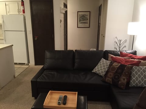 Open area looking away from fireplace and towards the entry door.