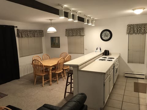 The Kitchen & bar with stove, dishwasher, microwave, fridge, and porcelain tile