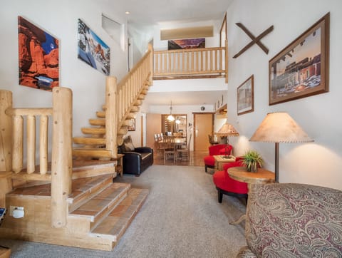 View from living room of stair case to second floor and dining room