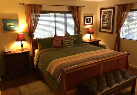 The master bedroom offers a king sized sleigh bed and views of the yard.