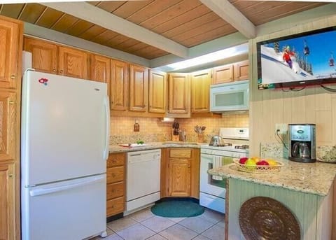 View of kitchen (and flatscreen TV)
