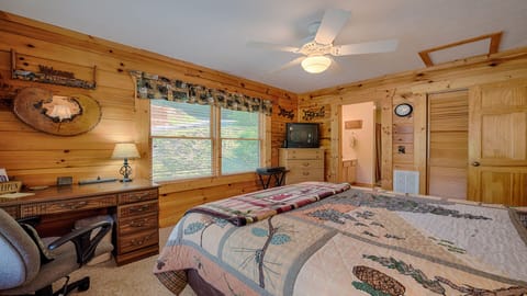 Guest bedroom with queen bed and view of bathroom