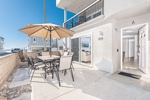 Ocean view from the coveted corner front patio, one house back from beachfront; includes outdoor dining, propane bbq grill, market umbrella.