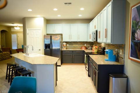 Granite counters, S/S appliances, stacked slate backsplash and pantry in kitchen