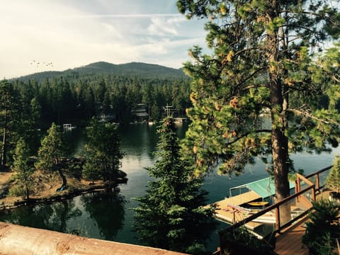 view from top deck includes island, mountains, dock area.