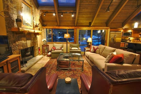 The Great Room with vaulted timber ceiling and wood burning fireplace