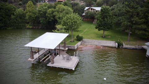 Aerial view of the boat dock, steps leading into the lake  and swimming area. 