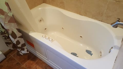 Separate tub and shower, hair dryer, slippers, towels