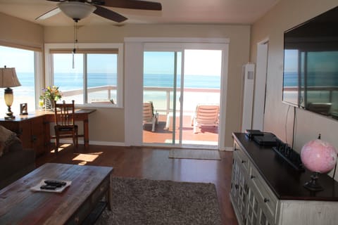 Living room with sliding glass door leading out to the deck