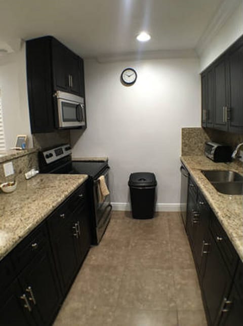 Vibrant and spacious kitchen with tile and marble finishes to compliment.