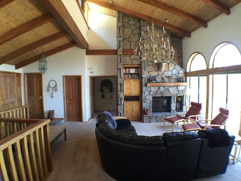 Living Room with 18' vaulted ceilings and rock fireplace.