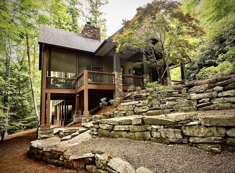 Luxurious cabin retreat with spacious deck and natural stone steps to the fire-pit