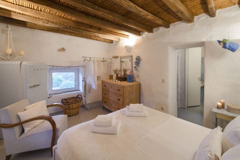 Master bedroom in the lower cottage, with queen-sized bed and antiques