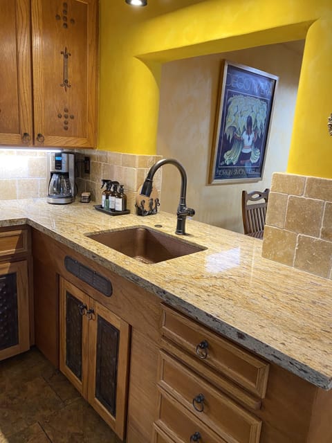 Beautiful copper sink coordinates with the hammered copper cabinet panels. 