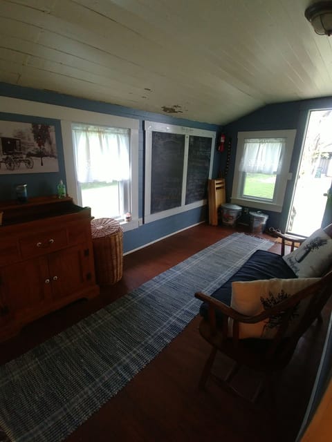Mud room with coat racks and a place to sit a spell.
