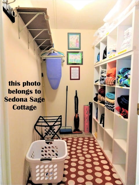 Walk-in closet with bedding supplies and storage for travel bags.