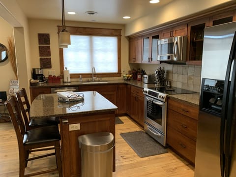Stainless steel appliances, pots and pans, coffee maker and plenty of dishes