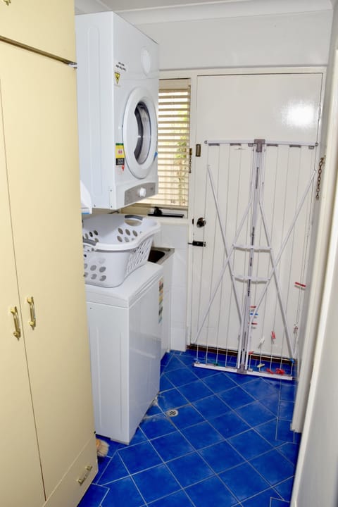 Laundry with washing machine and dryer and separate toilet 
