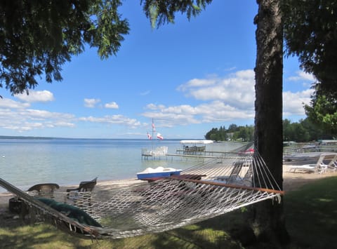 Shaded hammock overlooking sparkling Burt Lake and our sandy beach