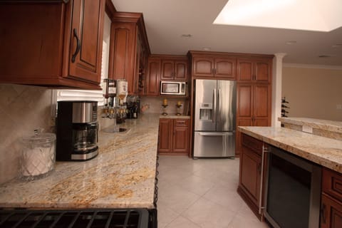 All wood custom cabinetry and granite counter tops. Wine cooler in the island.