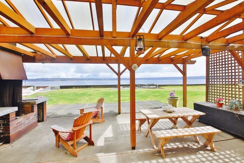 Expansive Lanai with massive wood burning fireplace, BBQ and dining area.