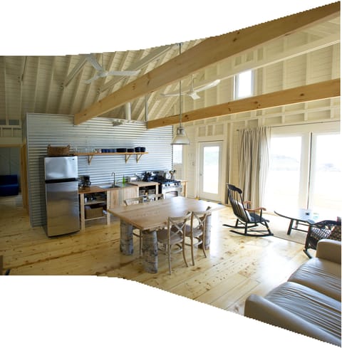 open concept living room/ kitchen, pine beams, wood floors