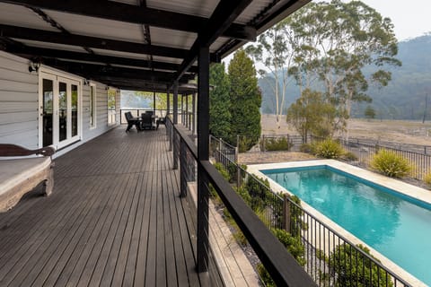 The deck wraps around the main cottage & looks over the pool, cabana & fire-pit