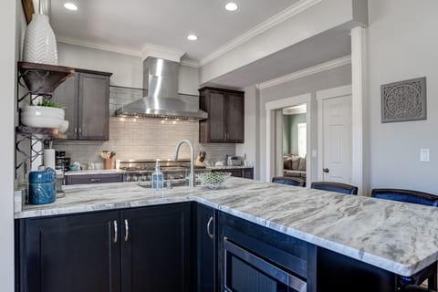 Kitchen island hosts seating for four and a large prep surface for family meals.