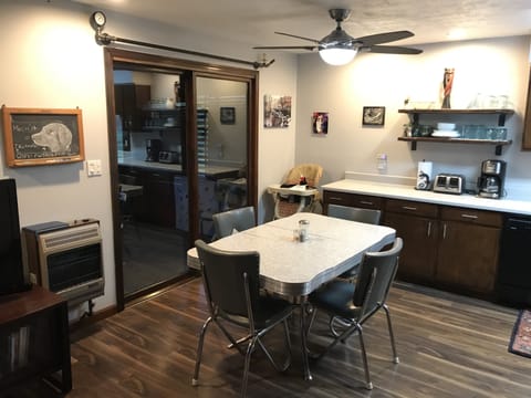 Dining Area with sliding door overlooking the wooded back yard. 