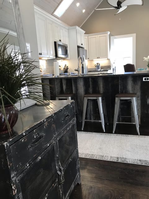 View into the kitchen from living room with barn wood framed bar