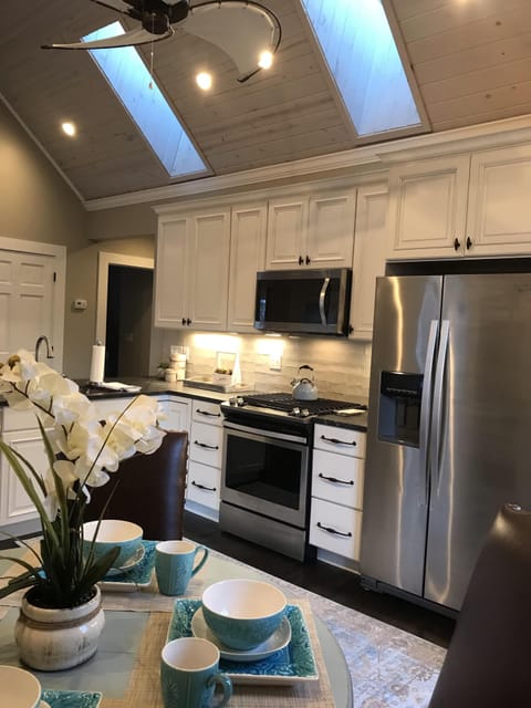 Gourmet kitchen with gas stove, vaulted ceilings and skylights