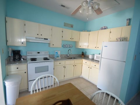 Wide-lens shows all of the kitchen area with table & chairs