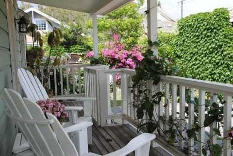 Front porch - enjoy your morning coffee surrounded by gorgeous flowers and singing birds!