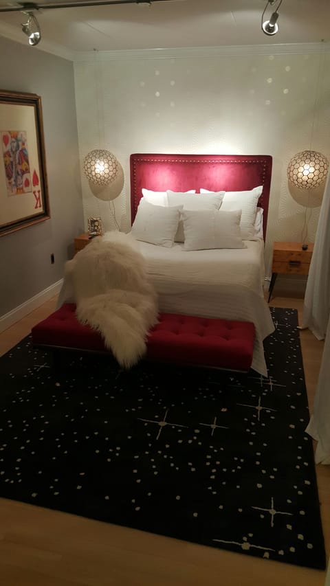 Queen bedroom with red velvet headboard