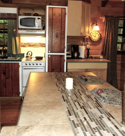  pass thru from entry to kitchenette shows small stove and microwave.